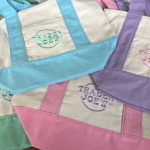 4 Trader Joe’s mini canvas bags. Blue, purple, pink and green.